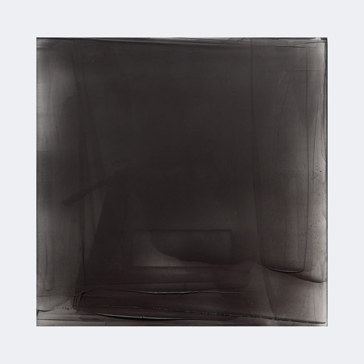 The artwork "Graphite Veil 1" by Debra Ramsay features a layered composition of translucent graphite shades in deep charcoal and muted black tones, creating an ethereal veil-like effect. The abstract, soft-edged forms and subtle textures evoke styles reminiscent of Mark Rothko's color field paintings and Agnes Martin's minimalist grids, emphasizing depth and atmospheric nuance.