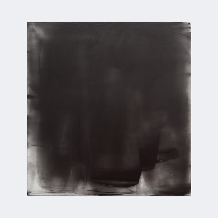 The artwork "Graphite Veil 4" by Debra Ramsay features a large, square composition dominated by deep graphite tones with subtle variations in darkness and texture, creating a translucent veil effect. The soft gradients and layered, smoky appearance evoke styles reminiscent of Mark Rothko’s color field paintings and Agnes Martin’s minimalist abstractions.