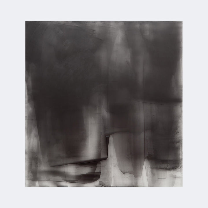 The artwork "Graphite Veil 5" by Debra Ramsay features an abstract composition with layered graphite textures creating a veil-like effect. Shades of deep gray and black blend softly with translucent washes, reminiscent of Mark Rothko’s color fields and Gerhard Richter’s blurred abstractions, evoking a contemplative, atmospheric mood.