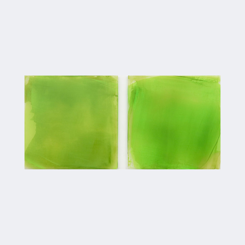 The artwork "Greens with Reversed Underpainting" by Debra Ramsay features two adjacent square panels dominated by rich, vibrant green hues with subtle gradients and translucent layers. The smooth, blended texture and minimalist abstraction evoke the meditative quality of Mark Rothko’s color field paintings and Helen Frankenthaler’s soaked color washes.