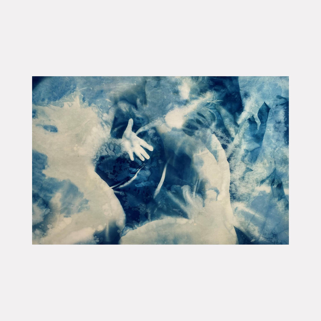 The artwork "Reach" by Cat Welch features an ethereal blend of blue and white hues with ghostly, overlapping human forms and an outstretched hand emerging from a textured, almost watercolor-like background. The style evokes the haunting surrealism of Salvador Dalí combined with the blurred motion reminiscent of Gerhard Richter’s abstract portraits.