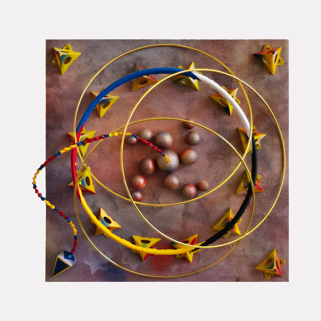 The artwork "3 Ring Circus" by Richard Alpert features a dynamic composition with overlapping concentric golden rings and colorful geometric star-shaped forms in yellow, red, and blue arranged on a textured, muted brown and purple background. The style evokes a playful surrealism reminiscent of Joan Miró and Alexander Calder’s kinetic sculptures.