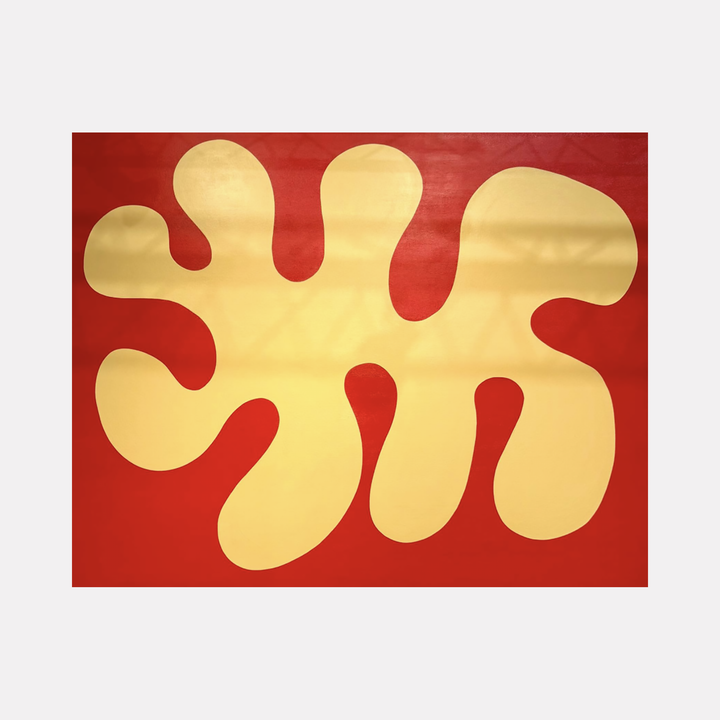 Rise by Shadia Sabagh displays a large, organic golden shape with rounded, flowing contours set against a bold red background, creating a warm and uplifting visual contrast that evokes a sense of growth and dynamic balance.