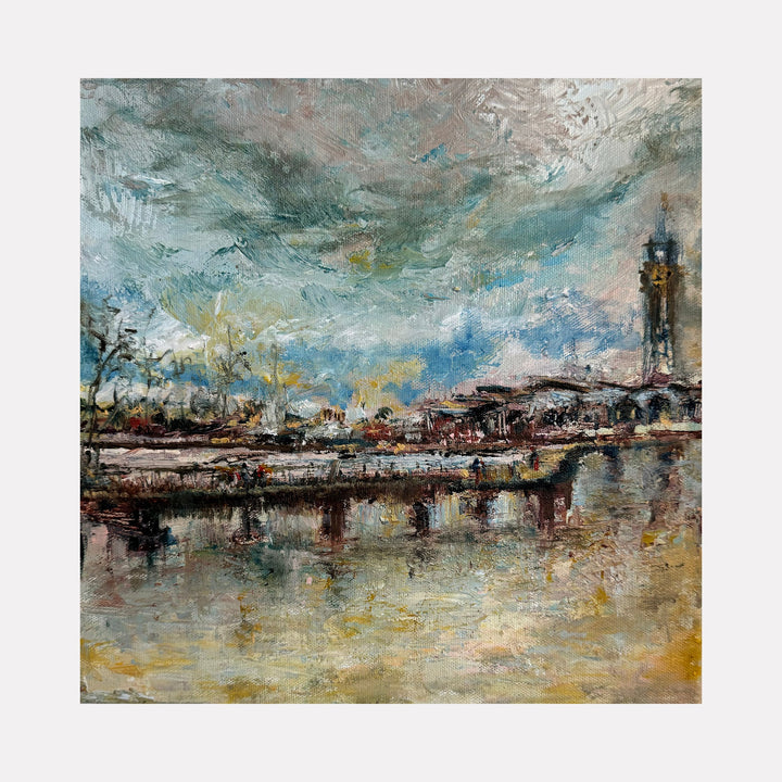 The artwork "Hoboken Lackawana Railway Station" by Rita BasuMallick depicts a textured impressionist scene featuring a historic railway station by the waterfront with a prominent clock tower, moody skies with swirling clouds, and reflections in the water rendered in muted blues, grays, and earthy tones, creating a contemplative atmosphere.
