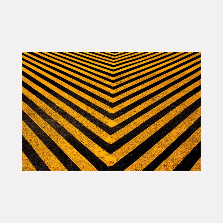 Road Paint 04 by Steve Edson features a bold geometric design with converging black and yellow diagonal stripes forming a striking chevron pattern, emphasizing sharp contrast and rhythmic repetition that creates a sense of depth and dynamic movement in a modern, urban-inspired abstract composition.