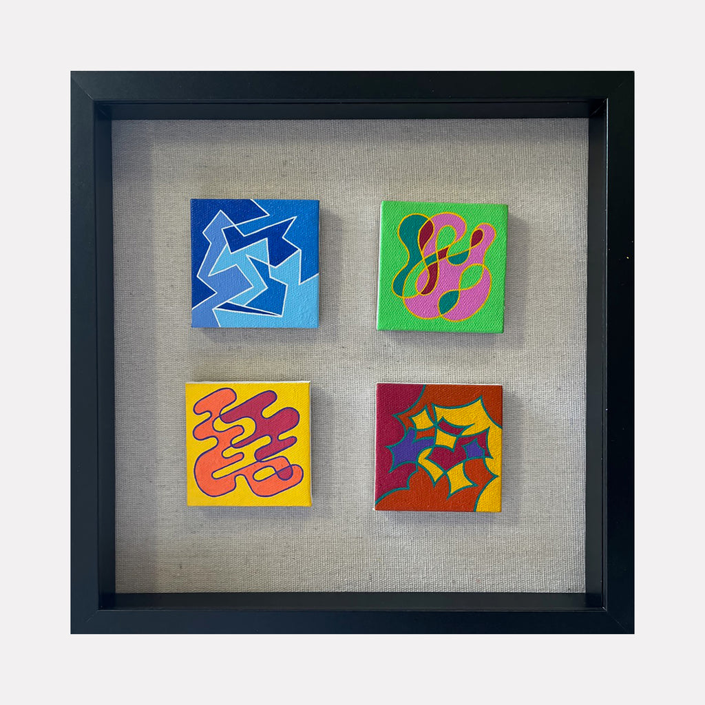 The artwork "Seasonal Phenomena III" by Joe Piscopia features four small square acrylic paintings on canvas, each with distinct abstract shapes and vibrant colors including blue, green, yellow, red, and orange. The pieces display smooth, curvilinear forms and sharp geometric lines, framed in a black box frame. Joe Piscopia.