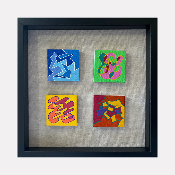 The artwork "Seasonal Phenomena III" by Joe Piscopia features four small square acrylic paintings on canvas, each with distinct abstract shapes and vibrant colors including blue, green, yellow, red, and orange. The pieces display smooth, curvilinear forms and sharp geometric lines, framed in a black box frame. Joe Piscopia.