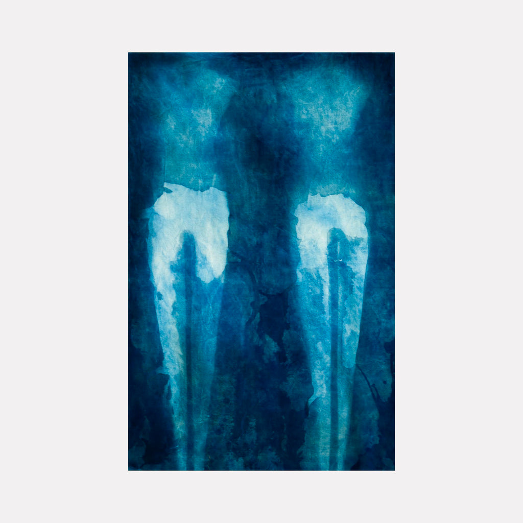 The artwork "Sisters" by Cat Welch features an abstract composition with deep blue and turquoise hues, highlighting two vertical, luminous, bone-like forms that evoke a sense of ethereal connection. The textured layering and fluid blending resemble the ghostly ambiance found in works by Mark Rothko and Yayoi Kusama.