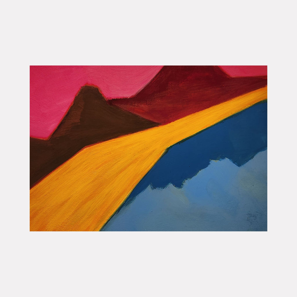 The artwork 'Slide' features bold abstract landscape forms with a vibrant pink sky, dark brown mountain silhouettes, and a sweeping golden-orange path that curves alongside a deep blue water body. Created in acrylic gouache on cotton paper by Joanie Flickinger, the composition demonstrates striking color contrasts and fluid geometric shapes.