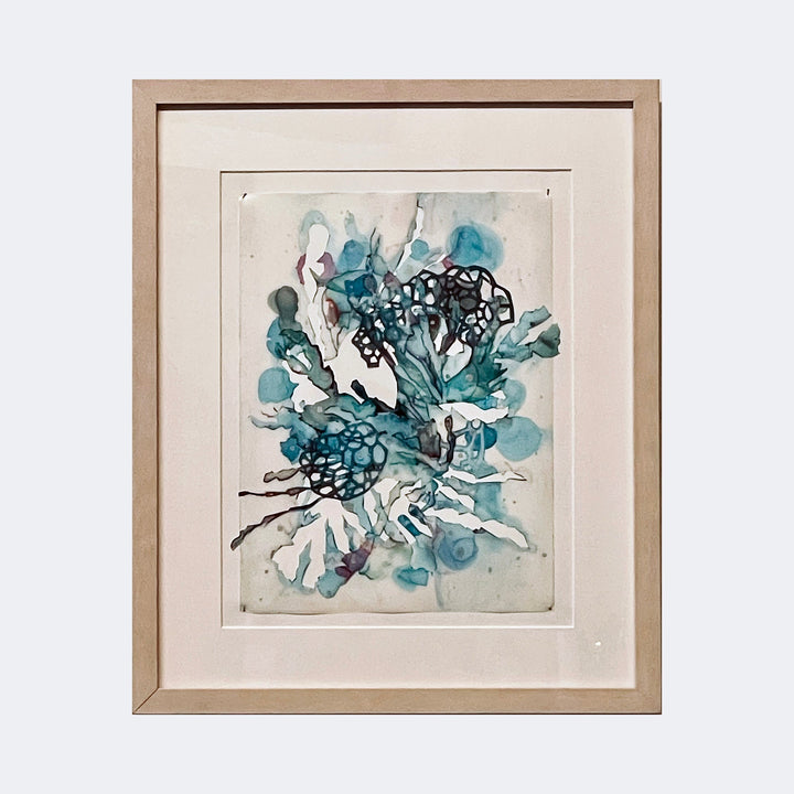 The artwork "Beauty of Chaos #9" by Sonomi Kobayashi features an abstract composition with fluid organic shapes in shades of teal, blue, and black. The piece showcases translucent watercolor textures blending with intricate dark web-like patterns, evoking a style reminiscent of Helen Frankenthaler’s color field works and Joan Miró’s biomorphic forms, framed in light wood.
