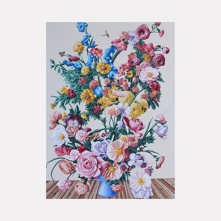 The artwork "Spring Flowers I" features a vibrant bouquet of various spring blooms in shades of pink, yellow, blue, and white arranged in a blue vase set on a wooden surface. The detailed petals, green foliage, and delicate textures create a lush, lively composition. The piece is by Carlos Gamez de Francisco.