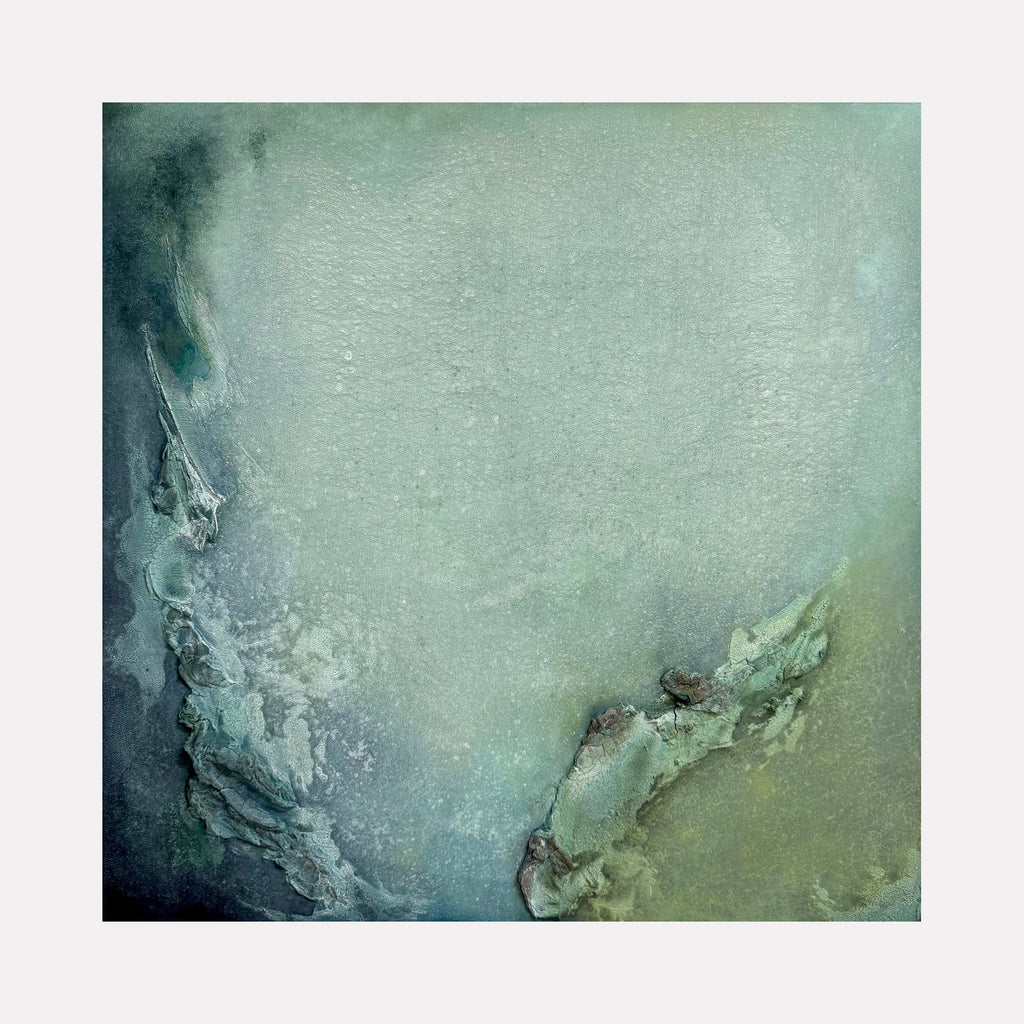 The artwork "Early Thaw" by Abbey Stace features an abstract composition with layered, textured surfaces in muted greens and greys, evoking melting ice or emerging spring landscapes. The subtle interplay of cold, organic forms recalls the atmospheric abstraction of Wolfgang Laib and the tactile depth found in Anselm Kiefer’s work.