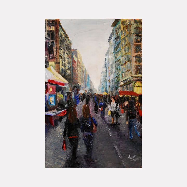 The artwork "Street Bazaar" depicts a bustling urban street scene with tall buildings lining both sides under a soft, muted sky. Figures with indistinct features walk along the textured pavement, surrounded by colorful market stalls and awnings. The impressionistic style uses rich, layered brushstrokes in earthy tones. Lauren Luna.