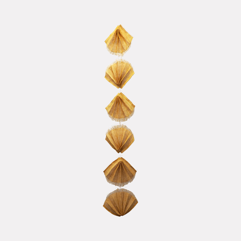 The artwork "Sunbeam" by Morgan Hale features a vertical arrangement of textured, golden-yellow fan shapes with delicate, translucent accents connecting each segment. The subtle layering and organic forms evoke a sculptural elegance reminiscent of Alexander Calder’s mobiles and the tactile abstraction found in Ruth Asawa’s wire sculptures.
