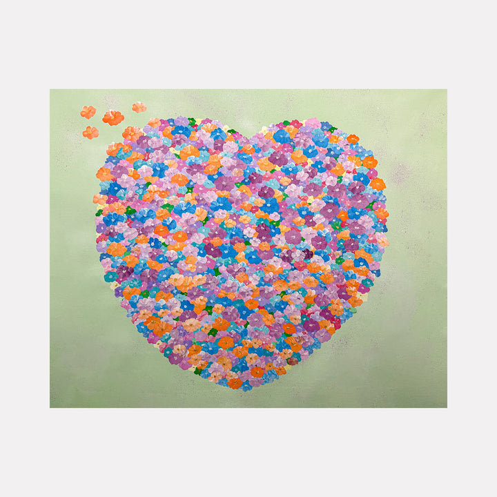 The artwork "Symphonies Of Love Number Fourteen" features a vibrant heart shape composed of small, colorful flowers in shades of orange, purple, blue, pink, and green, set against a soft pastel green background. The piece exhibits a pointillist style reminiscent of Georges Seurat, blending detailed textures and lively colors. Dorothea Sandra.