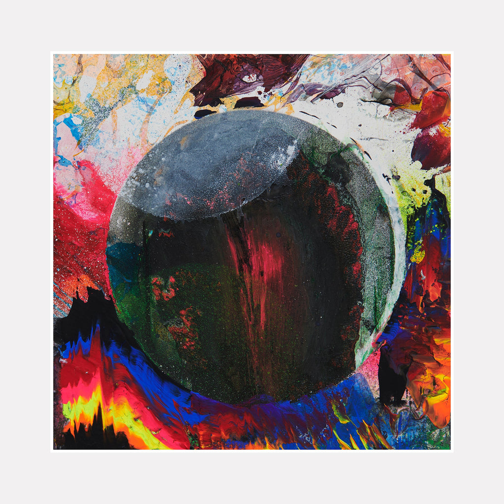 The artwork 'Worried About Black Holes' depicts a dark spherical mass surrounded by explosive bursts of vibrant colors. A deep black and green orb dominates the center, while swirling patterns of red, blue, yellow, and pink create a cosmic, nebula-like effect around it. Created using gouache, spray paint, and conte crayon on wood by Millie Benson.