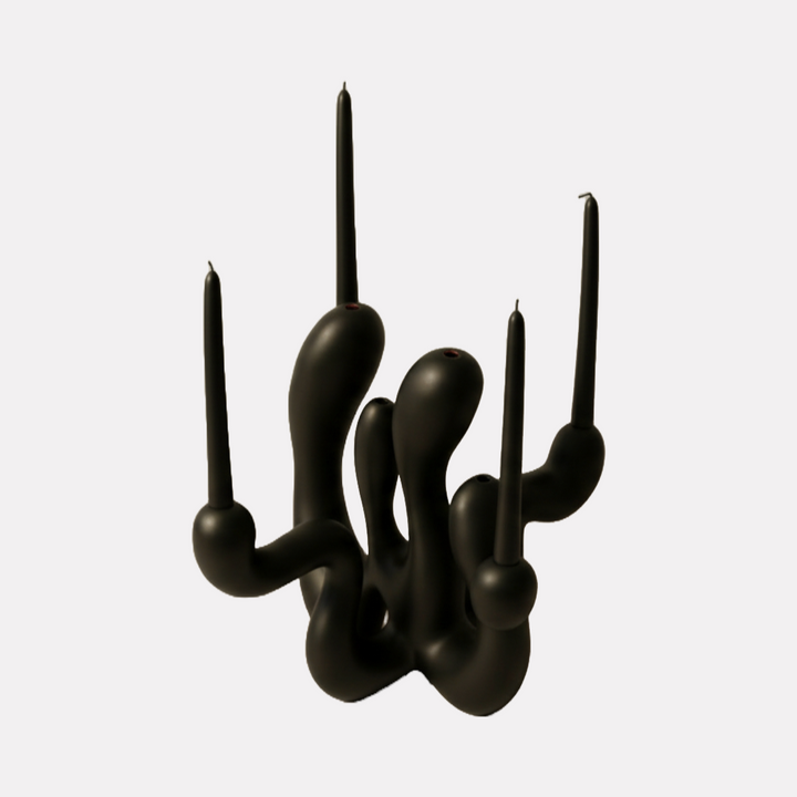 Hold the Light Sculptural Candleholder (Black) by Shadia Sabagh features a modern, abstract design with fluid, organic curves forming multiple candle holders in a matte black finish, blending artistic expression with functional elegance for a striking centerpiece.