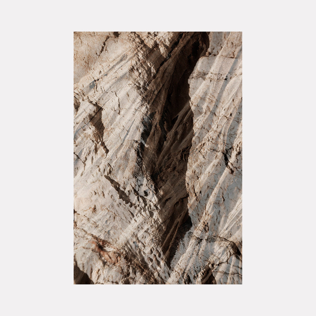 The artwork "erosion 8" by Eunice Pais presents a close-up of weathered rock with layered textures and soft shadows in muted beige and gray tones. The organic patterns and subtle erosion evoke the natural abstraction reminiscent of Richard Long’s landscape art and the minimalist earthworks of Olafur Eliasson.