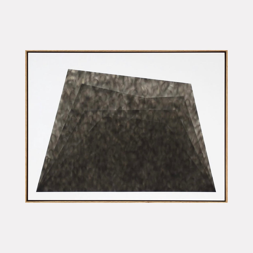 The artwork "Untitled 2" by Evan Ishmael features a monochromatic abstract composition of layered, trapezoidal forms in varying shades of black and dark gray. The textured, smoky surfaces and subtle gradients create depth and movement, evoking the minimalist abstraction and tonal explorations reminiscent of Robert Motherwell and Ellsworth Kelly.