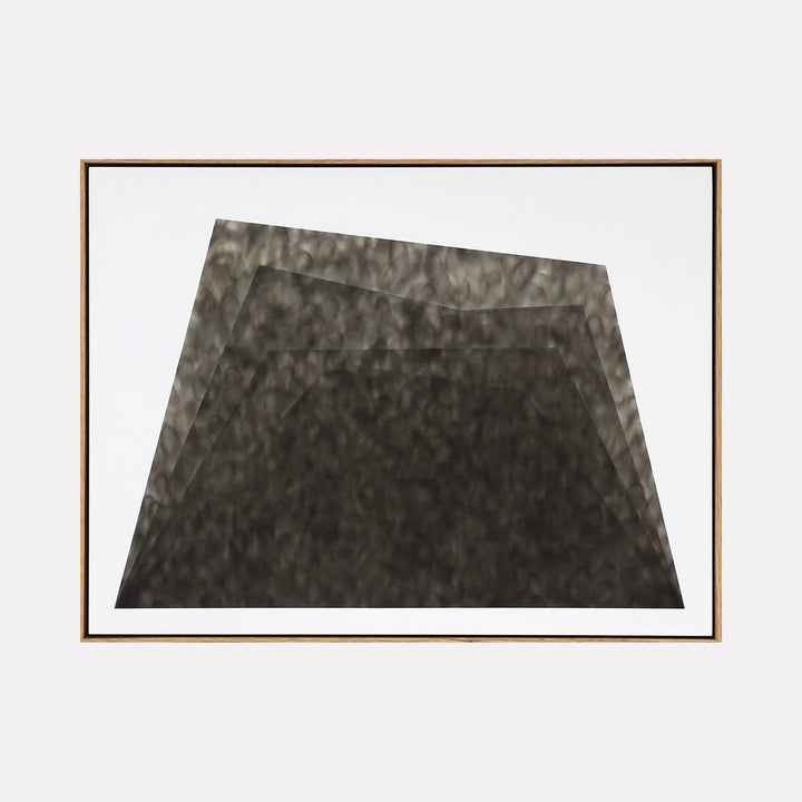 The artwork "Untitled 2" by Evan Ishmael features a monochromatic abstract composition of layered, trapezoidal forms in varying shades of black and dark gray. The textured, smoky surfaces and subtle gradients create depth and movement, evoking the minimalist abstraction and tonal explorations reminiscent of Robert Motherwell and Ellsworth Kelly.