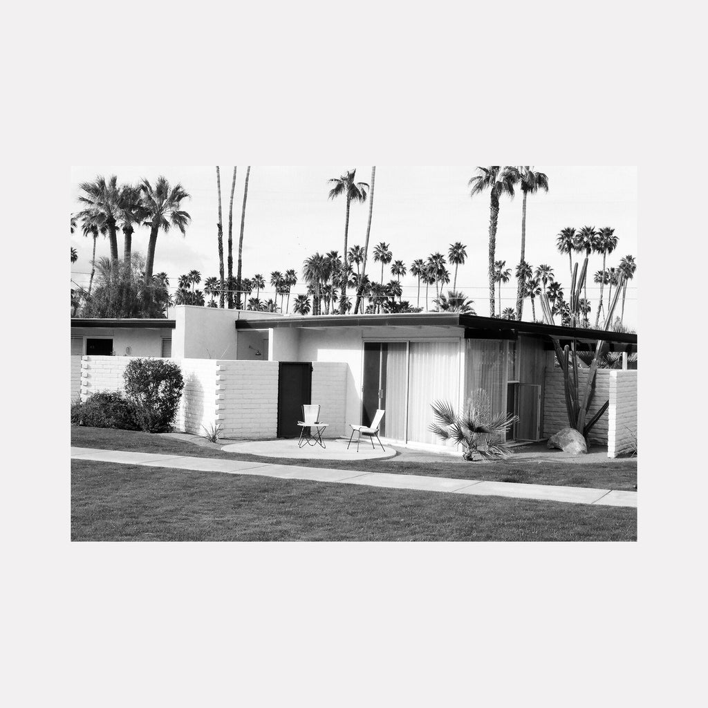 The artwork 'silence' by Esther Voisin captures mid-century modern architecture with palm trees, black and white film photography of desert bungalow