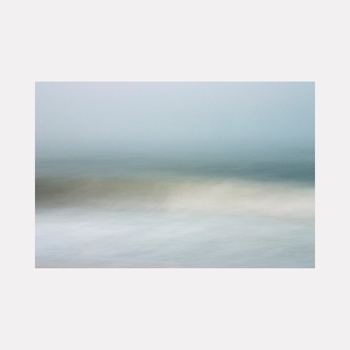The artwork "Whispers of the Sea" by Sandi Daniel features a soft, ethereal seascape with blurred layers of muted blues, grays, and pale beige tones. The smooth, flowing textures evoke a serene, meditative atmosphere, reminiscent of the minimalist abstractions found in works by Hiroshi Sugimoto and Agnes Martin.