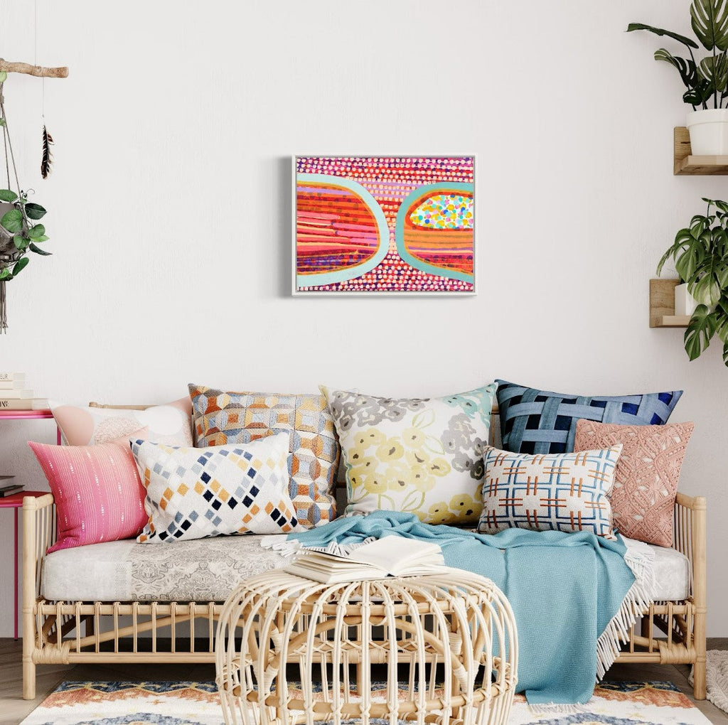 The artwork 'space, in my heart' by Taylor Binda features vibrant retro-style sunglasses painted in whimsical dotted patterns. The lenses showcase contrasting designs - one with horizontal stripes in orange and pink, the other filled with multicolored polka dots, both framed in mint green. The background displays a rhythmic pattern of pink and white dots, creating a playful, pop art aesthetic in acrylic on canvas.