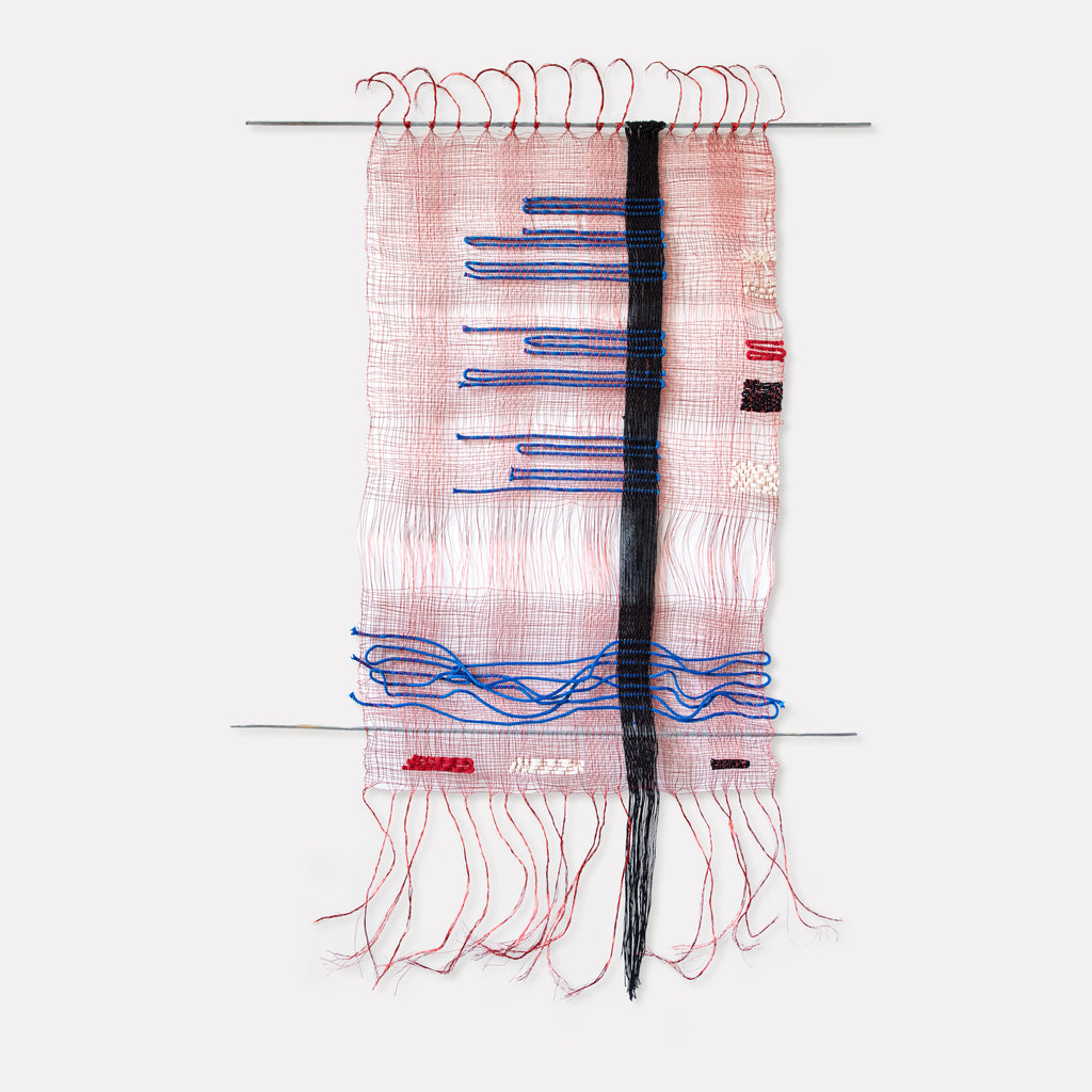 The artwork 'Svo-bo-dy! #1, Russian Morse Code' by Kathie Halfin features a delicate textile composition with pink cotton mesh background intersected by blue horizontal lines resembling Morse code patterns. A bold vertical black strip divides the piece, while copper wire creates graceful curves at the top and loose threads form organic fringe elements at the bottom.