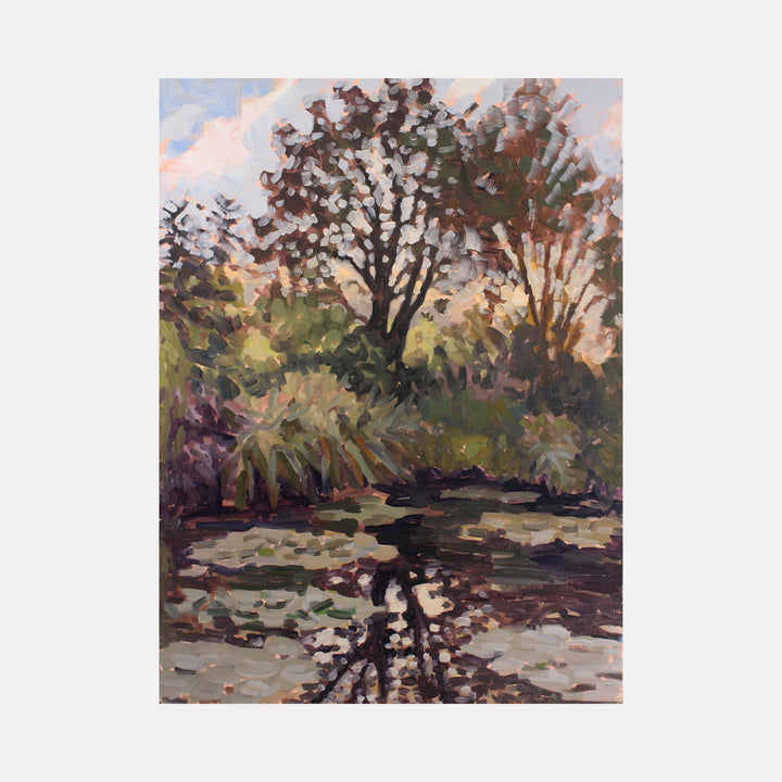 The artwork 'Sunrise in Monet's Garden' by Elody Gyekis depicts a tranquil pond reflecting dawn light through towering trees. Impressionistic brushstrokes capture rippling water, lush foliage, and a pink-tinged morning sky. Dark tree silhouettes mirror in the still water, creating a serene garden landscape rendered in oil on 12x12 inch panel.