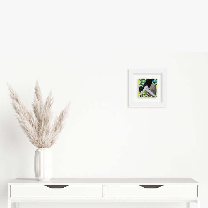 The artwork 'Fragment#11' by Winnie Sidharta features a delicate 5x5 inch mixed media composition combining watercolor and magazine elements on panel. The piece displays an abstract silhouette against vibrant green and yellow collaged background, framed in crisp white. A minimalist contemporary artwork styled with a decorative touch by Winnie Sidharta.