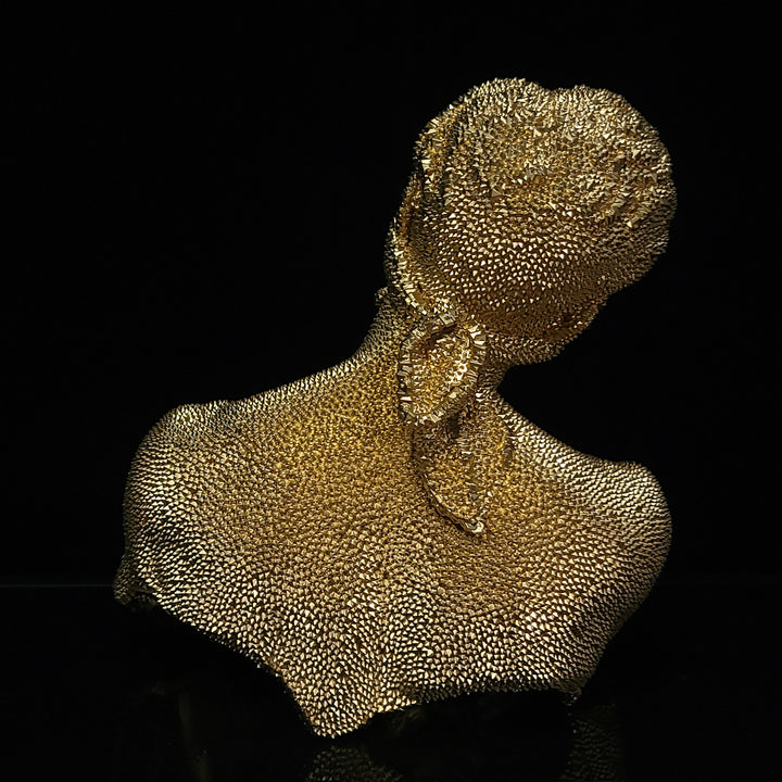 The artwork 'Thinking Blind - Original' by IvIvI features a textured gold resin bust sculpture against a black background. The figure's silhouette displays a contemplative pose with an upward-tilted head, showcasing intricate dotted patterns across its metallic surface. The 10-inch contemporary art piece exhibits a striking dimensional presence with its textural depth.