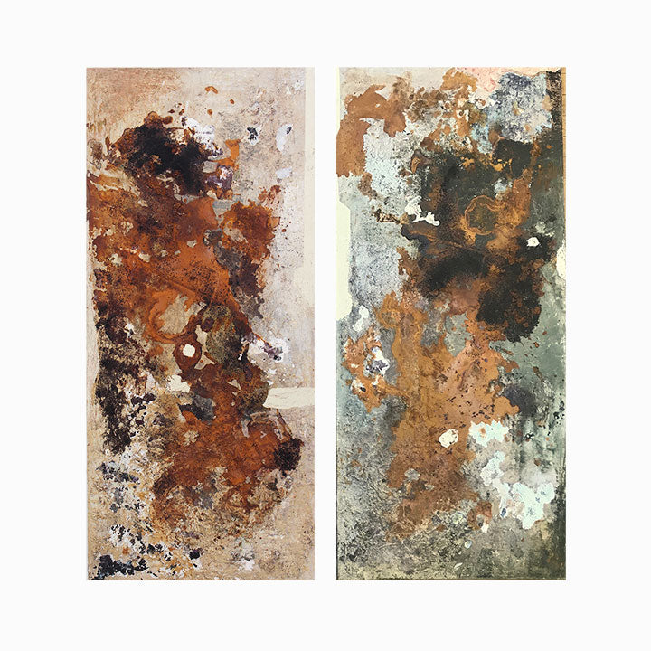 The artwork 'KÜF 6-7' by Sinejan Kılıç Buchina features two vertical panels with abstract expressions in earthy tones. Rust-colored patches blend with silvery grays and weathered whites, creating a textural composition reminiscent of naturally aged surfaces. The mixed media on canvas creates a weathered, organic effect with mottled patterns and layered paint techniques.