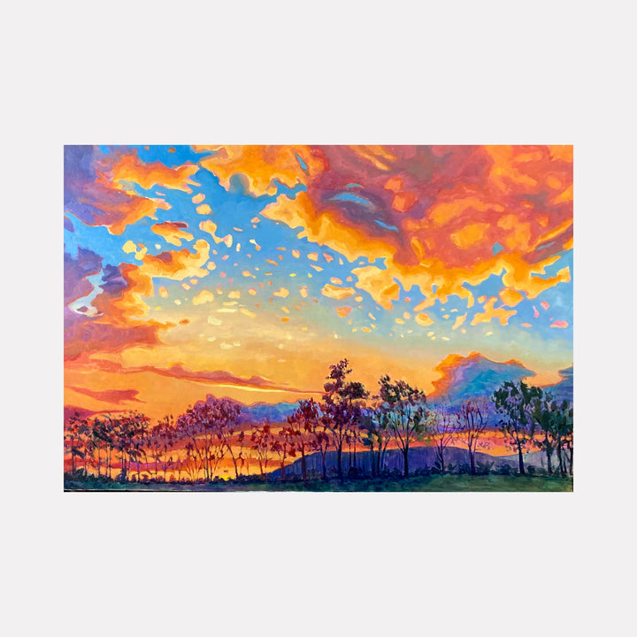 The artwork 'Sunset on Paradise' by Elody Gyekis captures a vibrant landscape with dramatic orange and purple clouds swirling across a turquoise sky. A silhouetted tree line stretches across the horizon, with mountains in the distance. The oil painting features bold brushstrokes and expressive color transitions, creating a dynamic sunset scene in a 12x12 inch panel format.