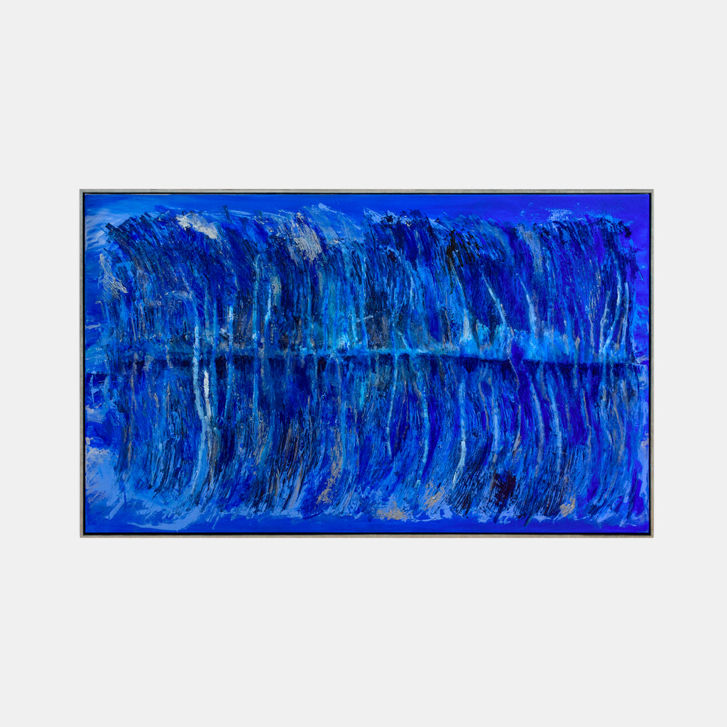 The artwork 'The Water's Edge by Moonlight' by Camilla Webster features dramatic vertical brushstrokes in varying shades of deep cobalt and cerulean blue, creating a mirror-like reflection effect. The textured acrylic on canvas suggests rippling water illuminated by moonlight, with subtle silvery highlights and darker navy undertones throughout the 37x61 inch composition.