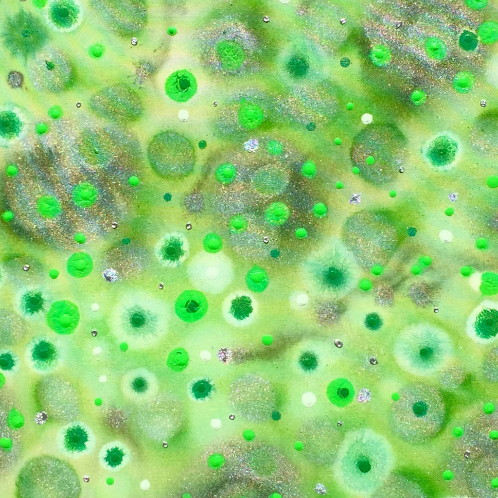 The artwork 'Greeniliscious' by Eric Jiaju Lee features a mesmerizing abstract composition of vibrant green orbs and circles floating in a luminous space. The painting showcases varying sizes of spherical forms with glowing centers, creating a microscopic or celestial effect. Metallic silver accents shimmer throughout the 35x35 inch acrylic canvas, adding depth and dimension to the ethereal green palette. By Eric Jiaju Lee.
