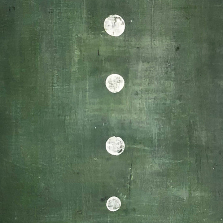 The artwork 'Green Stone' by Shira Toren features four white circular forms arranged vertically against a rich forest green background. Created with Venetian plaster and pigment on canvas, the 36x36 inch piece showcases a textured, weathered surface with subtle variations in the green hue. The white circles appear luminous, creating a striking contrast with the moody backdrop. By Shira Toren.