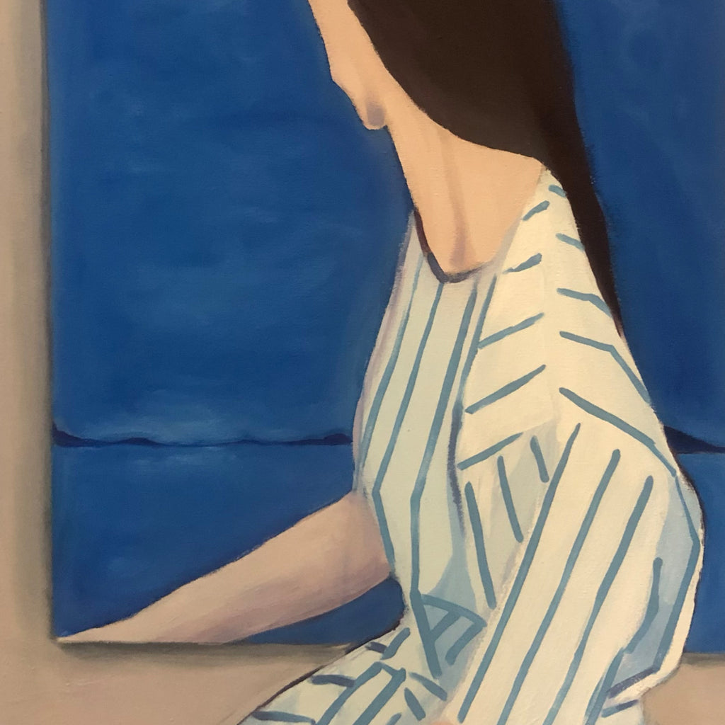The artwork 'Inside the Painting' features a figure in a white striped dress against a deep blue background, suggesting a seascape or horizon. The composition employs a minimalist style with clean lines and geometric patterns on the garment. The acrylic oil canvas creates a subtle texture and matte finish in soft, coastal-inspired colors. By Nikki Shapiro.