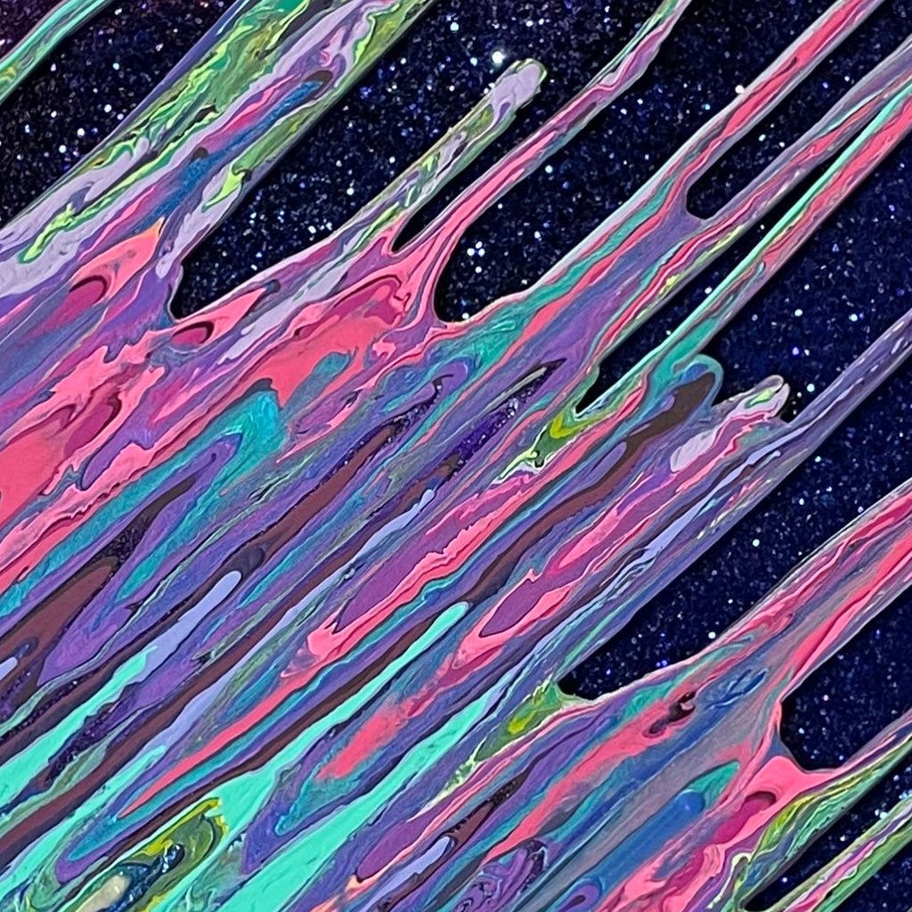 The artwork 'Galaxy Kinetic e-' by Paola Gracey features dynamic diagonal streaks of iridescent colors flowing across a starry black background. Swirling patterns of pink, turquoise, purple, and green create a fluid, cosmic effect enhanced by glitter and resin. The marbled texture resembles an ethereal aurora borealis or celestial energy streams in motion.