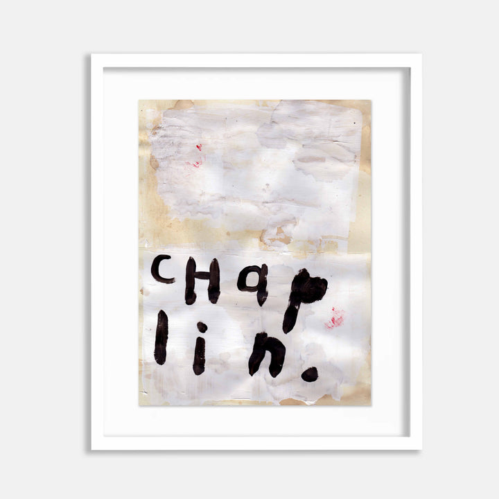 The artwork 'Chaplin' by Joseph ONeal features bold black typography on a textured, aged paper background. The letters appear hand-painted with raw, expressive strokes, creating a minimalist composition against a misty grey and cream backdrop with subtle coffee stains and mixed media elements. Art by Joseph ONeal.