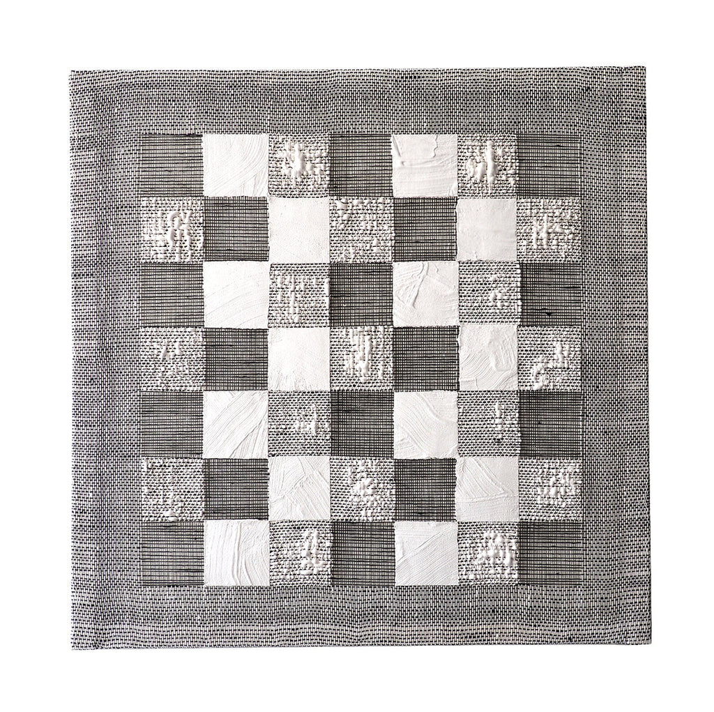 The artwork 'Checkerboard II' by Morgan Hale features a monochromatic square composition of alternating white plaster and gray linen squares arranged in a classic checkerboard pattern. The handwoven linen texture creates subtle linear striations, while the plaster squares showcase varied textural elements with a tactile, dimensional quality. The 18x18 inch piece combines traditional weaving with contemporary mixed media techniques.