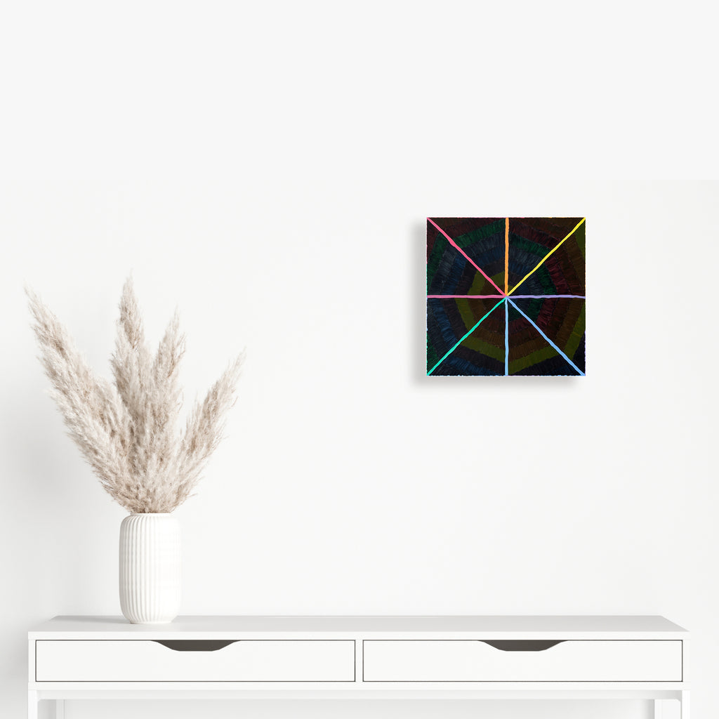 The artwork 'Chromatic' by Amber Heaton features a striking geometric composition with vibrant rainbow-colored lines intersecting to form a starburst pattern on a black background. The 12x12 inch acrylic painting on panel creates a dynamic radial design, with lines emanating from the center in eight directions, showcasing a spectrum of blues, pinks, yellows, and greens.