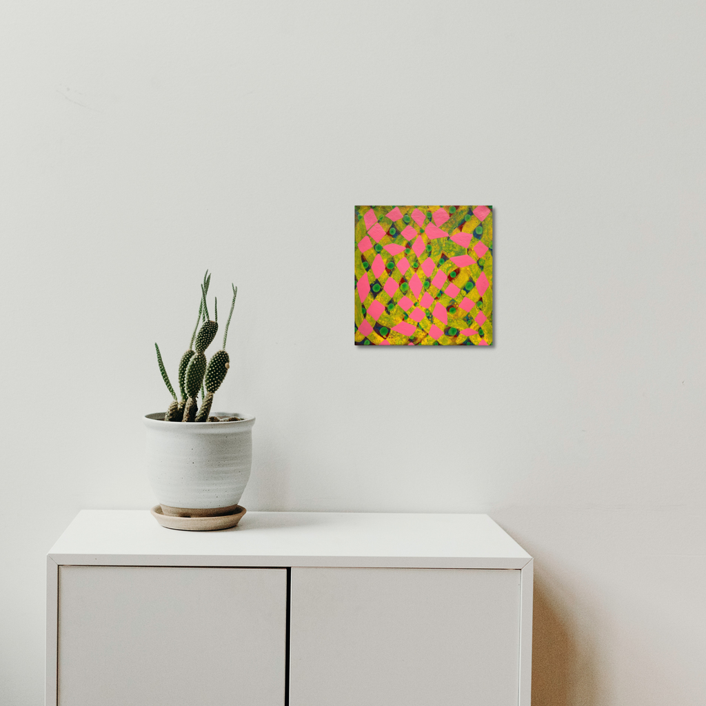 The artwork 'Composition No. 236' by Raul Ortiz features vibrant neon green geometric shapes scattered across a hot pink background on linen canvas. The 12x12 inch acrylic painting displays a dynamic pattern of abstract forms, creating a contemporary minimalist aesthetic. Shown mounted on a white wall above modern furniture with a potted cactus.