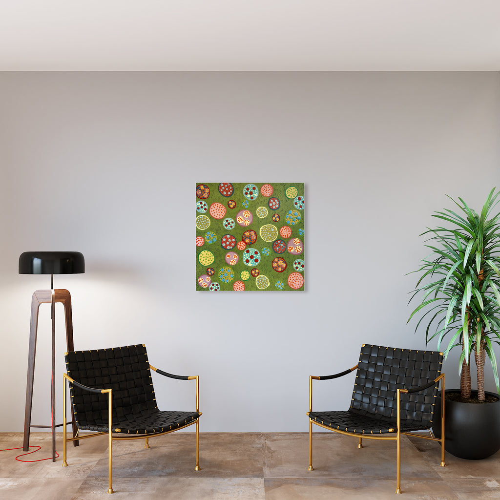 The artwork 'Cupcake' by Lori Kirkbride features a playful pattern of colorful abstract circular shapes on a sage green background. The whimsical composition includes dots, swirls, and flower-like patterns in vibrant orange, yellow, red, and white hues. Created with acrylic polymer and resin on panel, measuring 33x33 inches, the piece displays a modern, polka-dot inspired design with textural elements.