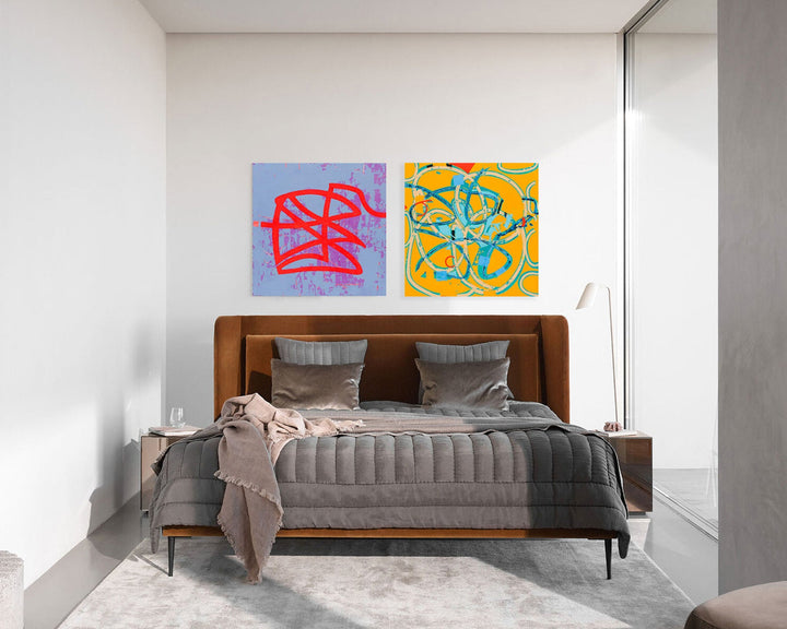 Curina Gift Card featuring modern bedroom interior with two vibrant abstract artworks above brown leather headboard bed. Bold geometric patterns in red against light blue and yellow backgrounds create striking contrast. Contemporary bedroom setup with gray bedding and minimalist decor showcases art rental possibilities by Curina.