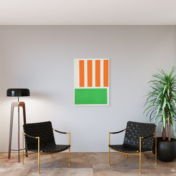 The artwork 'Devotion' by Shyun Song features a minimalist geometric composition with four vertical orange stripes against a white background, positioned above a solid green rectangular block. The abstract painting, executed in oil on canvas, creates a striking visual contrast between warm and cool colors in a contemporary style, perfectly balanced in its 40x30 inch frame.