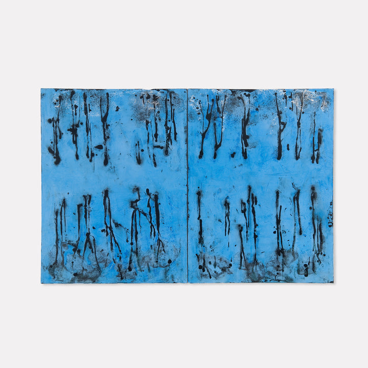 The artwork 'Ditto Dyptic' by Shira Toren features a striking diptych composition with abstract vertical drips and streaks in black against a vibrant azure blue background. Created with Venetian plaster pigment on canvas, the piece evokes a sense of falling rain or forest silhouettes through its textural contrasts and rhythmic pattern work across two panels.