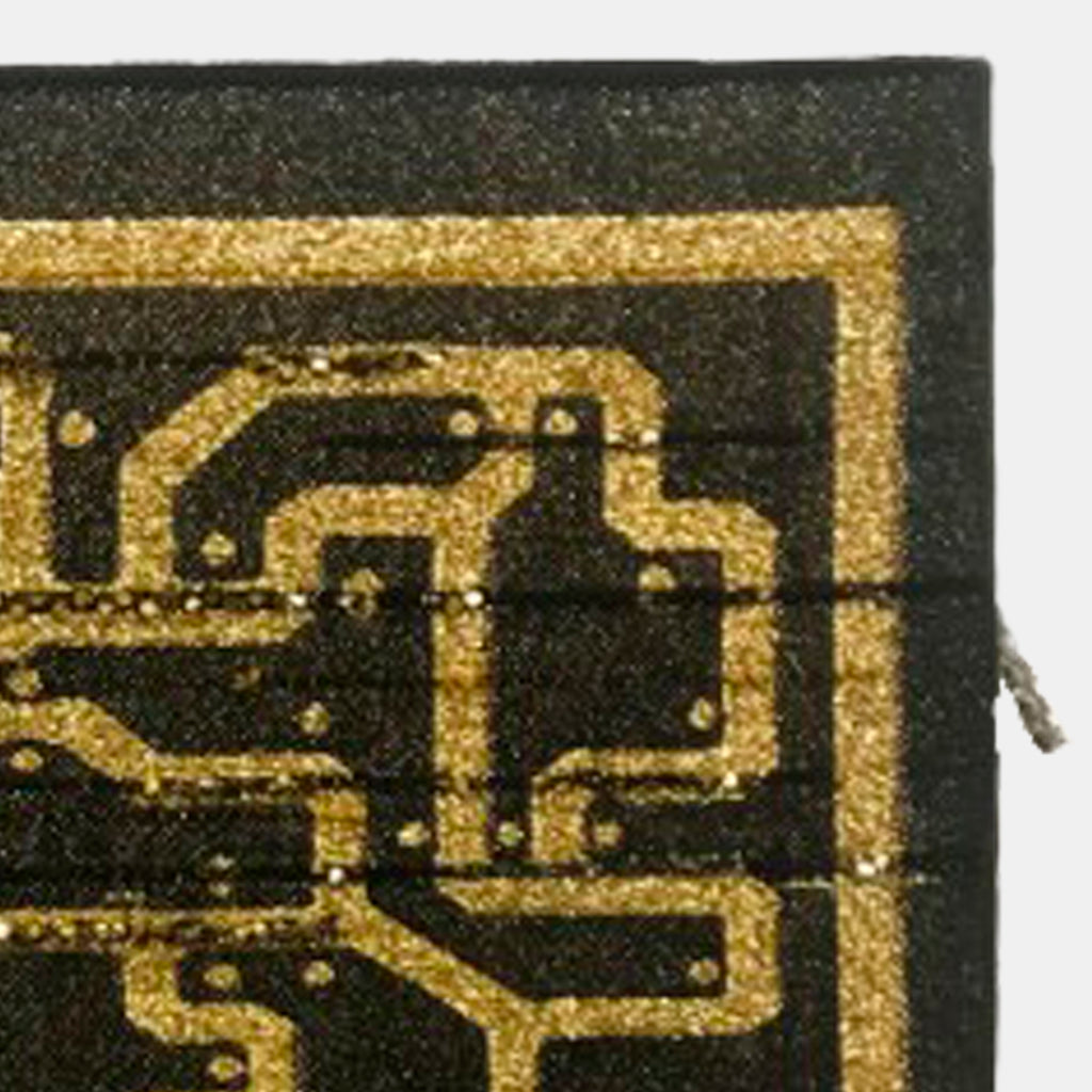 The artwork 'Divine Data Blueprint' by Robin Kang features intricate gold metallic circuit-like patterns woven against a deep black background. The Jacquard-woven textile artwork showcases geometric pathways and nodes reminiscent of electronic circuitry, creating a modern interpretation of traditional weaving techniques through cotton and metallic yarns on canvas.