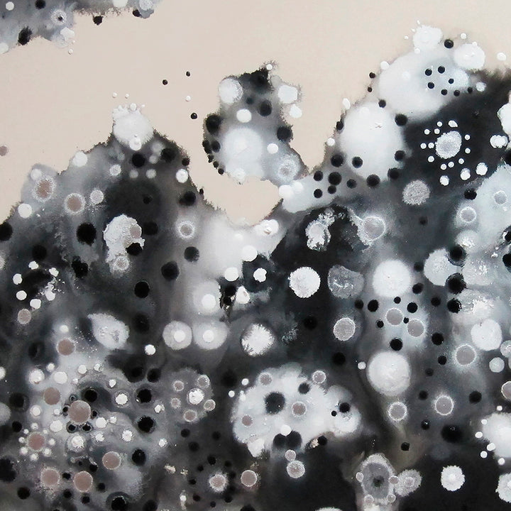 The artwork 'Luna's Landing' by Eric Jiaju Lee features abstract monochromatic patterns resembling a cosmic landscape. White circular orbs float across a dark charcoal backdrop, creating depth and movement. The spotty texture suggests lunar surfaces or celestial bodies, with varying sizes of dots scattered throughout the 60x60 inch acrylic canvas, by Eric Jiaju Lee.