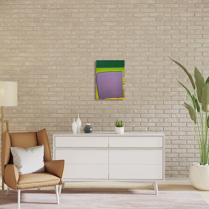 The artwork 'Escape Artist' by Jade Chan features bold geometric abstract composition with vibrant green, lime yellow, and lavender purple blocks layered in a dynamic arrangement. Oil on canvas painting displayed against textured brick wall, showcasing modern minimalist style with sharp edges and color blocking technique. Dimensions 22x16 inches.