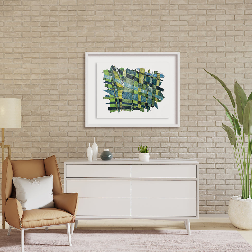 The artwork 'Feeling New' by Christina Massey features an abstract composition of interwoven green and blue brushstrokes and geometric patterns. Created using acrylic, linocut, and thread on canvas, the piece displays a dynamic weaving effect with textural elements. The artwork is elegantly displayed in a white frame against a neutral wall, showcasing its vibrant aquatic color palette. By Christina Massey.